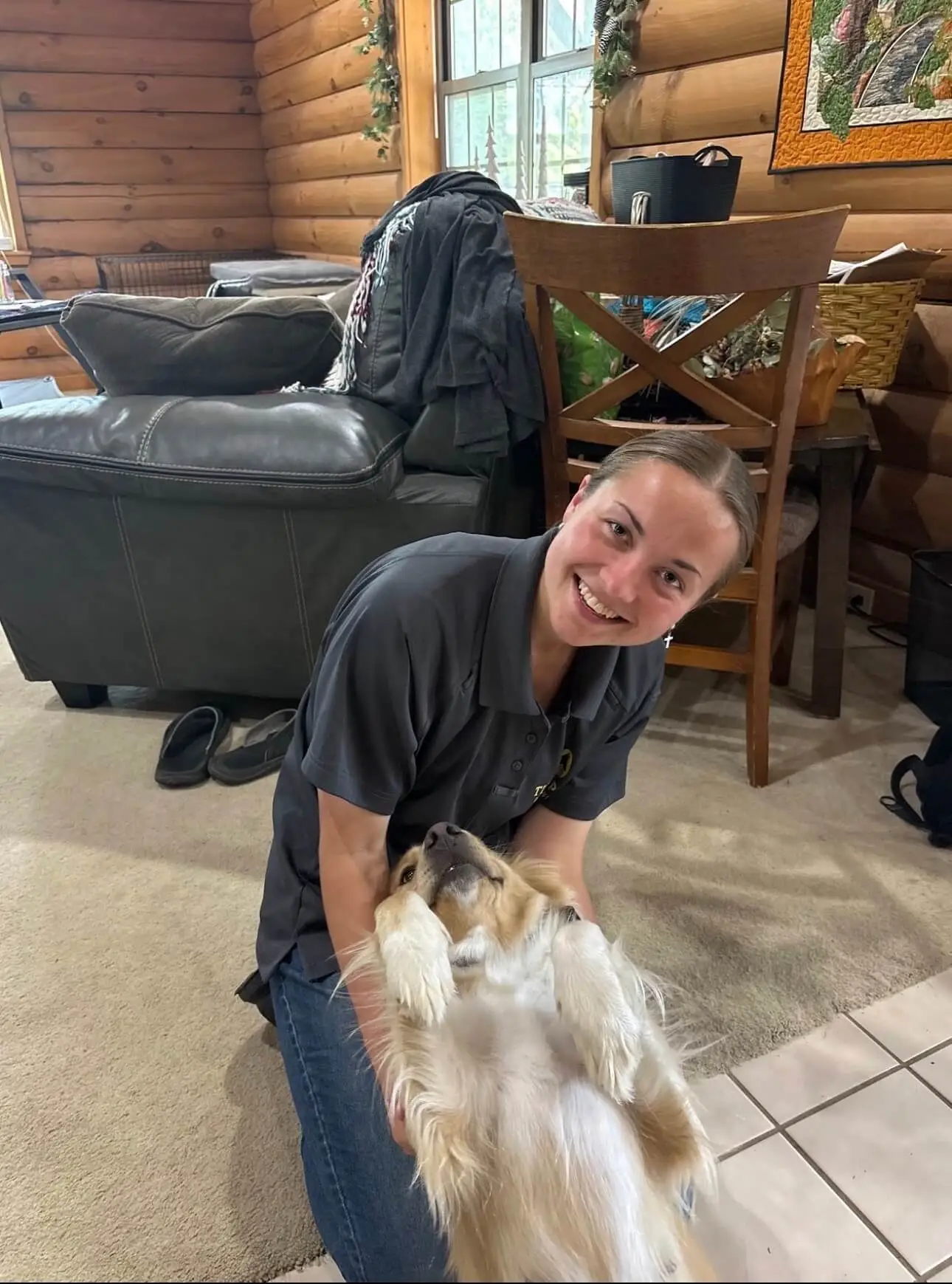 Alyssa, owner and lead trainer at Tip Top K9 NW Arkansas, with a golden retriever